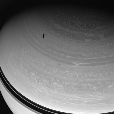 From farther North, than the North Pole...
Caption NASA:"Myriad vortices churn through Saturn's high Northern Latitudes while Dione's shadow drifts across the gas giant's face. 
This view looks toward the unilluminated side of the Rings from about 43° above the Ring-Plane. 

The image was taken with the Cassini Spacecraft wide-angle camera on May 7, 2008 using a spectral filter sensitive to wavelengths of infrared light centered at 752 nanometers. 
The view was obtained at a distance of approx. 1,2 MKM (about 760.000 miles) from Saturn. Image scale is roughly 69 Km (about 43 miles) per pixel".
Parole chiave: Saturn