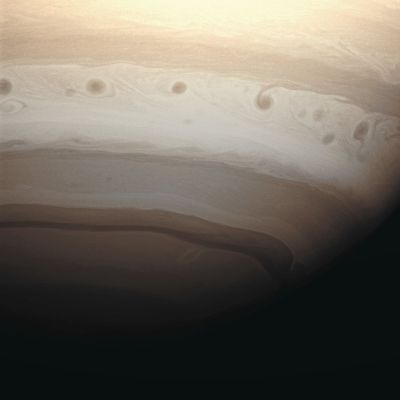 Storm Alley (MULTISPECTRUM-2; credits: Lunexit)
Caption NASA:"A line of dark vortices charge through Saturn's "Storm Alley" — such as a Region that has seen intensive storm activity since the Cassini Spacecraft began its observations of the Planet in early 2004. 

The image was taken with the Cassini Spacecraft wide-angle camera on May 19, 2008 using a spectral filter sensitive to wavelengths of infrared light centered at 728 nanometers. The view was obtained at a distance of approx. 863.000 Km (about 536.000 miles) from Saturn. 
Image scale is roughly 48 Km (about 30 miles) per pixel".
Parole chiave: Saturn - Upper Atmosphere