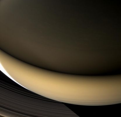 Saturn in the Ringshine (natural colors; credits: NASA)
Caption NASA:"Large regions of Saturn's night side are illuminated by the Planet's gleaming Rings. Except for a sliver of the sunlit crescent at left, this view shows a part of the Planet lit almost entirely by "Ringshine". 
The Southern Hemisphere, at bottom, receives its illumination from sunlight that strikes the Rings' southern face and is reflected onto the Planet. The Northern Hemisphere, at top, is lit by the feeble light that wends its way through countless ring particles to emerge on the Rings' north face. Despite the dim lighting on the northern part of the Planet, many cloud features can be seen there nevertheless. 
This view was acquired from about 44° above the Ring-Plane. At bottom, the Planet's shadow stretches across the D and C-Rings. 

Images taken using red, green and blue spectral filters were combined to create this natural color view. The images were obtained with the Cassini Spacecraft wide-angle camera on April 23, 2007 at a distance of approx. 901.000 Km (about 560.000 miles) from Saturn. 
Image scale is roughly 50 Km (about 31 miles) per pixel".
Parole chiave: Saturn - Southern Regions