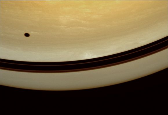 Lonely Shadow... (possible True Colors; credits: Lunexit)
Caption NASA:"The shadow of Tethys drifts across the face of Saturn. Nearby, shadows of the Planet's Rings form a darkened band above the Equator. This view looks toward Saturn from a vantage point 63° North of the Equator. 

The image was taken in visible green light with the Cassini Spacecraft wide-angle camera on Oct. 1, 2008. The view was acquired at a distance of approx 615.000 Km (about 382000 miles) from Saturn. 
Image scale is roughly 37 Km (approx. 23 miles) per pixel".
Parole chiave: Saturn