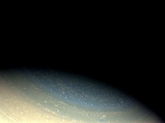 Polar Blue (possible True Colors; credits: NASA/JPL/Space Science Institute)
Caption NASA:"Saturn's North Pole retains its bluish hue in this true color Cassini image, even as Northern Winter is coming to an end. The azure blue of Saturn's Winter Hemisphere during the early Cassini prime mission still remains a puzzle. Over the course of time, the blue color has faded and has been replaced with bands of other hues (see also PIA11141). 
The North Pole is in shadow here, but a portion of its oscillating hexagonal pattern is visible. Storms create the look of a pockmarked surface. 

Images taken using red, green and blue spectral filters were combined to create this Natural Color view. The images were acquired with the Cassini Spacecraft wide-angle camera on Nov. 29, 2008 at a distance of approx. 1,1 MKM (about 683.000 miles) from Saturn and at a Sun-Saturn-Spacecraft, or Phase, Angle of 38°. 
Image scale is roughly 62 Km (about 39 miles) per pixel".
Parole chiave: Saturn - Upper Atmosphere