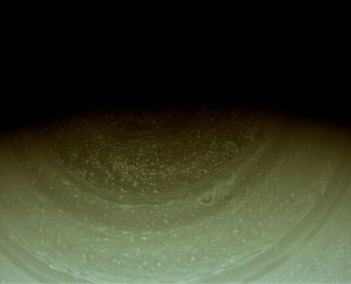 North Polar Hues (possible Natural Colors; credits: Lunar Explorer Italia)
Cpation NASA:"Cassini imaging scientists have waited years for the Sun to reveal the Hexagonal Wave Pattern (a.k.a.: The Hexagon) in the clouds of Saturn's North Pole, part of which can be seen at the top of this image from the Cassini Spacecraft. This mosaic combines four separate near-InfraRed images to show one full side of the Hexagon and two partial sides cut off by shadow. 
When the Spacecraft arrived in 2004, Winter darkened the North Pole. As the Planet continues its 29-year orbit, the Sun sheds more light on northern features and uncovers more of this strange, long-lived formation first observed in Voyager images of the illuminated Northern Pole from the early 1980's. 
False color images made from data collected by Cassini's Visual and InfraRed Mapping Spectrometer (VIMS) have previously captured the full six-sided pattern in the IR Light. (See PIA09188) 
South of the Hexagon at least five large storm systems can be seen spinning in a sea of smaller storms. 

The image was taken with the Cassini Spacecraft wide-angle camera on Dec. 1, 2008 using a spectral filter sensitive to wavelengths of near-iIR Light centered at 752 nanometers. The view was obtained at a distance of approx. 712.000 kilometers (442,000 miles) from Saturn and at a Sun-Saturn-spacecraft, or phase, angle of 69 degrees. Image scale is 39 Km (such as about 24 miles) per pixel".
Parole chiave: Saturn - Upper Atmosphere