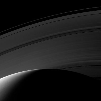 Daybreak from above
Caption NASA:"Day breaks on the Northern Hemisphere of Saturn in this image from Cassini. The D-Ring is hidden below the horizon, but, working outward from the Planet, this image shows the C, B, A and F-Rings. The moon Prometheus is a faint speck inside the thin F-Ring in the upper left of the image. 

This view looks toward the unilluminated side of the Rings from about 39° above the Ring-Plane. The image was taken with the Cassini Spacecraft wide-angle camera on March 20, 2009 using a spectral filter sensitive to wavelengths of Near-InfraRed Light centered at 853 nanometers. 
The view was obtained at a distance of approx. 888.000 Km (such as about 552.000 miles) from Saturn and at a Sun-Saturn-Spacecraft, or Phase, Angle of 121°. 
Image scale is roughly 50 Km (about 31 miles) per pixel".
Parole chiave: Saturn
