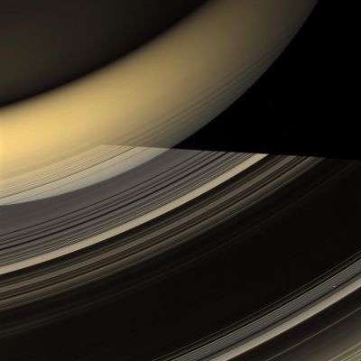 Between Day and Night... (Natural Colors; credits: NASA/JPL/Space Science Institute)
Caption NASA:"Rays of light from the Sun have taken many different paths to compose this glorious image of Saturn and its Rings. 
This view looks toward the unilluminated (North) side of the Rings and, at the top of the image, the night side of Saturn. Sunlight has been reflected off the illuminated side of the Rings to light the Planet's Southern Hemisphere, seen here as a bright band of yellow-orange. 
The Northern Hemisphere, in the top left corner of the image, is dimly lit by light diffusely scattered through the rings. The Planet's shadow cuts across the Rings, but light reflected off the Southern Hemisphere backlights parts of the C-Ring, making them visible in silhouette. Bright points of light in the image are stars occulted by the Rings. 

This view looks toward the unilluminated side of the Rings from about 41° above the Ring-Plane. Images taken using red, green and blue spectral filters were combined to create this Natural Color view. The images were acquired with the Cassini Spacecraft wide-angle camera on March 20, 2009 at a distance of approx. 892.000 Km (such as about 554.000 miles) from Saturn. 
Image scale is roughly 50 Km (about 31 miles) per pixel".
Parole chiave: Saturn