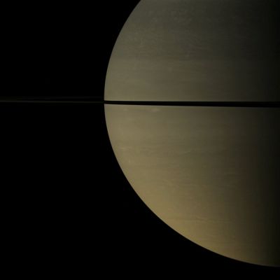 Narrow Shadow
Caption NASA:"From just above the Plane of Saturn's Rings, the Cassini Spacecraft snapped this shot of Saturn two months after Saturn's August 2009 Equinox, showing the shadow of its Rings as a narrow band on the Planet. 
Cassini is looking toward the sunlit side of the rings from about 1° above the Ring-Plane. 
The novel illumination geometry that accompanies Equinox lowers the Sun's angle to the Ring-Plane, significantly darkens the Rings, and causes out-of-plane structures to look anomalously bright and cast shadows across the Rings. These scenes are possible only during the few months before and after Saturn's Equinox, which occurs only once in about 15 Earth years. 

Before and after Equinox, Cassini's cameras have spotted not only the predictable shadows of some of Saturn's moons (see, for instance, PIA11657), but also the shadows of newly revealed Vertical Structures in the Rings themselves (see PIA11665). 

The image was taken with the Cassini Spacecraft wide-angle camera on Oct. 16, 2009 using a spectral filter sensitive to wavelengths of Near-InfraRed Light centered at 752 nanometers. The view was obtained at a distance of approx. 1,5 MKM (such as about 932.000 miles) from Saturn and at a Sun-Saturn-Spacecraft, or Phase, Angle of 83°. 
Image scale is roughly 86 Km (approx. 53 miles) per pixel".
Parole chiave: Saturn