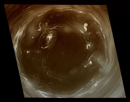 Southern Turbulence (False Colors; credits: Lunexit)
Caption NASA:"This detailed Cassini view of the monstrous vortex at Saturn's South Pole provides valuable insight about the mechanisms that power the Planet's Atmosphere. 
This view is 10 times more detailed than any previous image of the Polar Vortex. See PIA11103 for a more oblique, wide-angle view that provides context for this close-up. 

Previous images revealed an outer ring of high clouds surrounding a Region previously thought to be mostly clear air interspersed with a few puffy clouds that circulate around the center. This new image shows that what looked like puffy clouds at lower resolution are actually vigorous convective storms that form yet another distinct, inner ring. In other words, they are deep convective structures seen through the atmospheric haze. One of the deeper structures (at the 10 o'clock position) has punched through to a higher altitude and created its own little vortex. The ring is similar to the eyewall of a terrestrial hurricane, but much larger. The clear air there is warm, like the eye of a terrestrial hurricane, but on Saturn it is locked to the pole, whereas a terrestrial hurricane drifts around. 

Convective structures are small regions of intense upwelling air, but the clear air of the vortex eye indicates that this is generally an area of downwelling. Convection is an important part of the planet's energy budget because the warm upwelling air carries heat from the interior. In a terrestrial hurricane, the convection occurs in the eyewall. Here it seems to occur in the eye as well. The camera filter used for this image captures light at wavelengths where atmospheric gases like Methane are fairly transparent, allowing for detailed views of deep cloud features. Other filters (see PIA09859) use light that is strongly absorbed by Methane gas; the light bounces off the high clouds, making them visible, but gets absorbed before it reaches the low clouds. Such "Methane-Band" images of the South Polar Vortex reveal that the convective clouds do not reach up to the base of the stratosphere, as convective clouds on Earth do. This view was acquired from 56° below the Ring-Plane. The image has been digitally reprojected to show the scene as it would appear to an observer positioned directly above the Pole. 

The image was taken with the Cassini Spacecraft narrow-angle camera on July 14, 2008, using a combination of two spectral filters sensitive to wavelengths of polarized visible light centered at 617 and infrared light centered at 750 nanometers. The view was obtained at a distance of approx. 392.000 Km (243.000 miles) from Saturn and at a Sun-Saturn-Spacecraft, or Phase, Angle of 60°. 
Image scale is roughly 2 Km (a little more than 1 mile) per pixel".
Parole chiave: Saturn - Upper Atmosphere - The South Pole