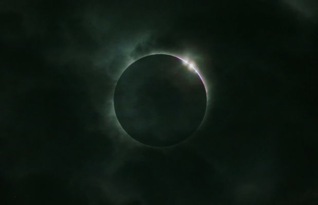 A "Diamond Ring" among the clouds
Da "NASA - Picture of the Day" del giorno 8 Agosto 2009:"Cloudy skies over Wuhan, China hid the delicate Solar Corona during July's Total Eclipse of the Sun. Still, the Moon's silhouette was highlighted by these glistening diamonds as the Total Eclipse Phase ended. Caused by bright Sunlight streaming through dips and valleys in the irregular terrain along the Moon's edge, the effect is known as Baily's Beads, named after Francis Baily who called attention to the phenomenon in 1836. 
The dramatic appearance of the beads at the beginning or end of a Total Solar Eclipse is also known as the Diamond Ring effect. In this remarkable image, a small, pinkish solar prominence can also be seen along the edge, below the diamonds".
Parole chiave: Artistic Pictures