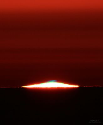 A "Green Flash" from the Sun
Dalla Rubrica "NASA - Picture of the Day" del giorno 4 Gennaio 2011:"Many people think it is just a myth. Others think it is true but its cause isn't yet known. Adventurers pride themselves on having seen it. 
What is it?
It's a "Green Flash" from the Sun. The truth is the Green Flash does exist and its cause is well understood. 

Just as the setting Sun disappears completely from view, a last glimmer appears startlingly green. 
The effect is typically visible only from locations with a low, distant horizon, and lasts just a few seconds. A Green Flash is also visible for a rising Sun, but takes better timing to spot. 

A dramatic Green Flash, as well as an even more rare Blue Flash, was caught in the above photograph recently observed during a Sunset visible from Teide Observatory at Tenerife, Cannary Islands, Spain. 
Obviously, the Sun does not partly turn either green or blue: the effect is caused by different layers of the Earth's Atmosphere, together acting like a prism".
Parole chiave: From Earth Pictures - Professional Pictures