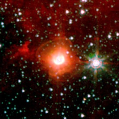 Bipolar Nebula
Caption NASA:"A luminous blue variable star in our galaxy, named HD168625, surrounded by a bipolar nebula that is similar to the one around SN1987A. 
SN1987A was a supernova that exploded in 1987 in the Large Magellanic Cloud, and was the nearest supernova in about 400 years. 

Rings near the equator are sometimes seen around stars that shed mass from their surfaces, but the larger rings above the poles are very rare. Tipped toward Earth and illuminated by the star, the rings look like ellipses in images taken with NASA's Spitzer Space Telescope. 

The image was taken in 2004 by the infrared array camera on Spitzer at wavelengths between 3,6 and 8 microns. The massive star at the center, which lies within the constellation Sagittarius, is about 7.200 Light-Years from Earth". 
Parole chiave: From Space Images - Spitzer Space Telescope