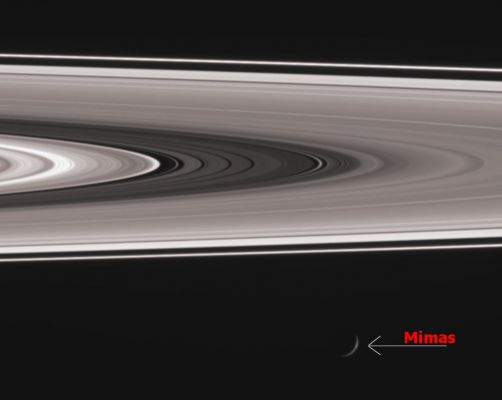 Mimas and the Rings
Caption NASA:"A recently discovered diffuse ringlet shines brightly in the Cassini Division as Mimas cruises past at bottom. Most of the main Rings are comprised of particles ranging from marble-size to house-size. In contrast, the brightness of this ringlet (seen right of center) when viewed at a high phase angle (the Sun-Saturn-Spacecraft angle) indicates it contains a large quantity of microscopic particles, which were likely generated by the disruption of a larger body. Such an event was probably recent, since this ringlet was not observed by the Voyager spacecraft in 1980 and 1981. 
This view looks toward the lit side of the Rings from about 1° below the Ring-Plane. Mimas, which is in the foreground between Cassini and the Rings, is 397 Km (about 247 miles) wide. See PIA08330 and PIA08331 for other views of the new ringlet. 

The image was taken in visible light with the Cassini spacecraft wide-angle camera on Nov. 18, 2006 and from a phase angle of 140°. Cassini was then at a distance of about 1,2 MKM (about 800.000 miles) from Saturn. Image scale is roughly 7 Km per pixel".
Parole chiave: Saturn's Rings and Mimas