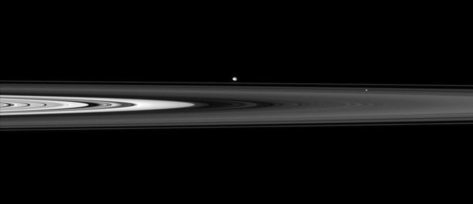 Other "Brothers in the Night": Pan and Pandora
Caption NASA:"The Cassini spacecraft skims past Saturn's Ring-Plane at a low angle, spotting two ring moons on the far side. 
Pan (26 Km, or about 16 miles across) sits within the Encke Gap right of center. Beyond the F-Ring hovers Pandora (84 Km, or approx. 52 miles across). 
This view looks toward the unilluminated side of the Rings from less than 1° above the Ring-Plane. 

The image was taken in visible light with the Cassini spacecraft narrow-angle camera on June 14, 2007 at a distance of approx. 1,6 MKM (about 1 MMs) from Saturn. Image scale is roughly 10 Km (about 6 miles) per pixel".
Parole chiave: Saturn's Moons - Pan and Pandora