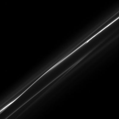 Just like a "Ribbon"...
Caption NASA:"The ever-changing F-Ring appears as wisps of smoke in this image taken downstream of the Shepherd Moon, Prometheus. 

The image was taken in Visible Light with the Cassini Spacecraft narrow-angle camera on Oct. 23, 2008 at a distance of approx. 437.000 Km (about 272.000 miles) from Saturn and at a Sun-Saturn-Spacecraft Angle of 89°. 
Image scale is roughly 2 Km (a little more than 1 mile) per pixel".

Nota Lunexit: un sincero Grazie alla NASA per aver pubblicato questa immagine la quale risolve - diremmo in via definitiva - il dubbio che era nato a proposito del possibile fenomeno di distorsione ottica imputabile ad un campo gravitazionale (e/o magnetico) di grande portata ed estremamente vicino a Cassini.
Parole chiave: Saturn's Rings - The "F-Ring"