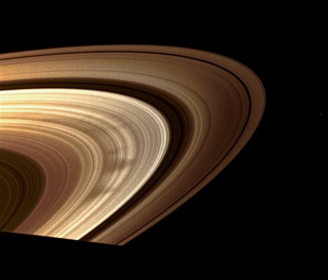 Spokes in the Rings of Saturn (Natural Colors; credits: Lunar Explorer Italia)
Caption NASA:"On November 2008 Cassini snapshot showcases a classic view of the triangular shape typical of many of the spokes in Saturn's outer B-Ring. Small particles in the Ring compose the Spokes and these wedge-shaped patterns seem to be appearing more often as Saturn approaches Equinox. 
The moons Pan, Pandora and Janus are also visible. Janus is the farthest outside the Rings. Pandora orbits outside the faint F-Ring. Pan is near the top right of the image and can be seen as a faint sphere cutting a path in the thin black strip of the Encke Gap in the A-Ring. 

This view looks toward the sunlit side of the rings from about 12° below the Ring-Plane.The image was taken in visible light with the Cassini Spacecraft wide-angle camera on Nov. 10, 2008 at a distance of approx. 1 MKM (about 639.000 miles) from Saturn and at a Phase Angle of 29°. 
Image scale is roughly 58 Km (about 36 miles) per pixel".
Parole chiave: Saturn's Rings