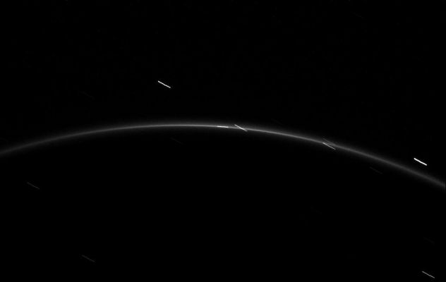 Moonlet in the "G"-Ring
Caption NASA:"The faint "G"-Ring surrounding Saturn offers up a glimpse of its newfound tiny moonlet. The moonlet is near the center of this image. 
A long exposure of 46" was required to capture the light from this tiny object and "G"-Ring, so the moonlet and a few stars have been smeared by motion, the stars showing up as short diagonal dashes. 
The moonlet has also been smeared and appears to be a short vertical dash that is aligned with the Ring. 
In August 2008 Cassini scientists spotted this moonlet, dubbed S/2008 S 1. It orbits in an arc, or partial ring, within the "G"-Ring. Imaging team scientists estimated the moonlet's diameter at about half a kilometer (one-third mile). For earlier images of this moonlet, see PIA11148. 

This view looks toward the unilluminated side of the Rings from about 14° above the Ring-Plane. The image was taken in Visible Light with the Cassini Spacecraft narrow-angle camera on Feb. 20, 2009. The view was acquired at a distance of approx. 1,2 MKM (about 746.000 miles) from Saturn. Image scale is roughly 7 Km (a little more than 4 miles) per pixel".
Parole chiave: Saturn's Rings - "G" Ring