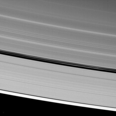 Encke Ringlets
Although Saturn's moon Pan is absent from this image of the A-Ring's Encke Gap, the moon's handiwork is still displayed. 
The two ringlets seen in the gap are maintained by the gravitational action of Pan (about 28 Km, or approx. 17 miles across). To learn more about this process, see also PIA07528. 
The point of light near the bottom of the image is a star. 

This view looks toward the unilluminated side of the Rings from about 41° above the Ring-Plane. The image was taken in Visible Light with the Cassini Spacecraft narrow-angle camera on April 17, 2009. The view was obtained at a distance of approx. 1,3 MKM (about 808.000 miles) from Saturn and at a Sun-Saturn-Spacecraft, or Phase, Angle of 115°. 
Image scale is roughly 8 Km (about 5 miles) per pixel.
Parole chiave: Saturn's Rings - "A" Ring