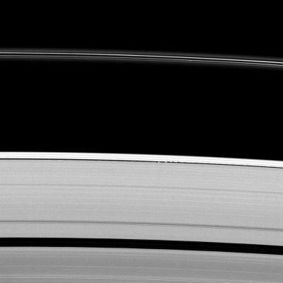 Gravity-induced "Ondulations"
Caption NASA:"Saturn's moon Daphnis gives a scalloped look to the edge of the A-Ring as the moon orbits within the Keeler Gap. 
Daphnis is the bright spot in the narrow gap near the center of the image. Since the gap is not much larger than the moon, the small moon's gravity is great enough to perturb the particles in the Ring and create the wavelike patterns seen here. See also PIA09850 to learn more. 

This view looks toward the unilluminated side of the Rings from about 61° above the Ring-Plane. The image was taken in Visible Light with the Cassini Spacecraft narrow-angle camera on April 30, 2009. The view was acquired at a distance of approx. 1,5 MKM (such as about 932.000 miles) from Daphnis and at a Sun-Daphnis-Spacecraft, or Phase, angle of 73°. 
Image scale is roughly 9 Km (a little less than 6 miles) per pixel".
Parole chiave: Saturn's Rings - "A" Ring
