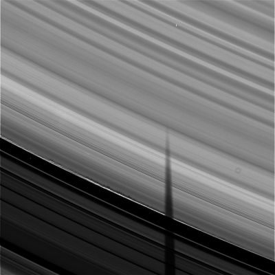 A "Wall" on the Rings
Caption NASA:"What's causing unusual jagged shadows on Saturn's Rings? No one is yet sure. As Saturn nears Equinox, its Rings increasingly show only their thin edge to the Earth and Sun. As a result, Saturn's moons now commonly cast long shadows onto the Rings. An example of this is the elongated vertical shadow of Mimas seen on the above right. 
The series of shorter, jagged shadows that run diagonally, however, are more unusual. Now Saturn's Rings have been known to be made of particles for hundreds of years, but these particles have so far escaped direct imaging. 
It is therefore particularly exciting that a preliminary hypothesis holds that these jagged shadows are silhouettes of transient groups of ring particles temporarily held close by their own gravity. Future work will surely continue, as the robotic Cassini Spacecraft orbiting Saturn that took the above image will continue to photograph Saturn's magnificent Rings right through Saturn's equinox this August (2009)".
Parole chiave: Saturn's Rings