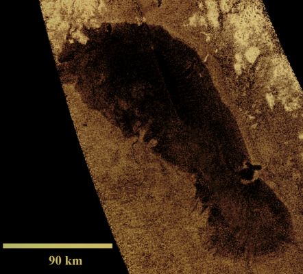 Ontario Lacus
This image of Ontario Lacus, the largest lake on the Southern Hemisphere of Saturn's moon Titan, was obtained by NASA's Cassini Spacecraft on Jan. 12, 2010. 
North is up in this image. Objects appear bright in this radar image when they are tilted toward the Spacecraft or have rough surfaces. The lake surface appears dark because it is smooth. The Northern Shoreline features flooded River Valleys and Hills as high as about 1 Km (3000 feet). 
A smooth, wave-sculpted Shoreline, like that seen on the S/Eastern side of Lake Michigan, can here be seen on the N/Eastern side of the lake. 
Smooth lines parallel to the current shoreline could be formed by low waves over time, which were likely driven by winds sweeping in from the West or South-West. 
The S/Eastern shore features a round-headed Bay intruding into the shore. The liquid-filled depressions appear to be relatively recent.

The middle part of the Western Shoreline shows the first well-developed Delta observed on Titan. The shape of the Delta shows that liquid flowing down from a higher plain has switched Channels on its way into the Lake, forming at least two lobes. Examples of this kind of Channel switching and wave-modified deltas can be found on Earth at the Southern end of Lake Albert between Uganda and the Democratic Republic of Congo in Africa and the remains of an ancient lake known as Megachad in the African country Chad.

Titan is the only other world in our Solar System known to have standing bodies of liquid on its Surface. Because Surface temperatures at the Poles average a chilly 90 Kelvin (about minus 300 degrees Fahrenheit), the liquid is a combination of Methane, Ethane and Propane, rather than water. 

Ontario Lacus has a surface area of about 15.000 square Km (approx. 6000 square miles), slightly smaller than its terrestrial namesake, Lake Ontario.
Parole chiave: Titan