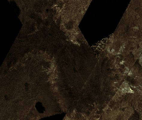 Lake-like Feature near the South Pole of Titan
Caption NASA:"This mosaic of image swaths from Cassini's Titan Radar Mapper, taken with the Synthetic-Aperture Radar (SAR), features a large Dark Region several hundred kilometers across that differs in several significant ways from potential lakes observed on Titan. 
It is not as dark to the radar as many lakes (including lakes seen here), and the nature of the margin is unusual. It has many characteristics in common with lakes, including its channels and interior, yet its differences distinguish it from other similar features. Some similarities are seen with the dark feature in Titan pass T7 (see PIA03563). 

At top (North), the feature has characteristics of a shoreline, with round bay-like margins and channels that drain into it; at left (West) and right (East) it is rimmed by bright, feathery, branching channel-like structures, some of which extend for tens of kilometers. Within the Dark Feature some details can be seen, some of which seem to be extensions of the channels draining into the Dark Feature. 

The mosaic is near the South Pole, centered near 82° South and 205° West. It includes data from Titan passes T39, T55, T57, T58, and T59, collected between December 2007 and July 2009. The individual swaths vary in resolution and illumination angle, so the edges are visible and surface features look somewhat different across swath boundaries, but the regional view can still be understood. As more SAR image swaths of Titan are collected by Cassini, mosaics of those images reveal features that cannot be appreciated within the individual observations".
Parole chiave: Titan