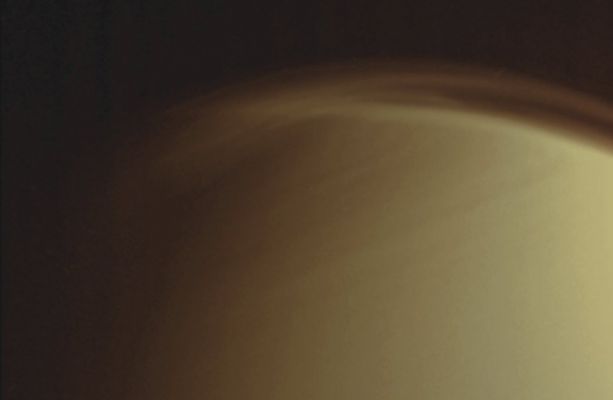 Titan's foggy Northern "Cap" (Absolute Natural Colors; credits for the additional process. and color.: Dr Paolo C. Fienga - Lunexit Team)
Caption NASA:"The complex and dynamic Atmosphere of Titan displays multiple Haze Layers near the North Pole in this view, which also provides an excellent look at the detached Stratospheric Haze Layer that surrounds the moon at lower Latitudes. 
North on Titan is up and rotated 20° to the left. 

The image was taken with the Cassini Spacecraft narrow-angle camera on March 16, 2006, using a filter sensitive to wavelengths of UltraViolet Light centered at 338 nanometers. The image was obtained at a distance of approx. 1,2 MKM (about 800.000 miles) from Titan and at a Sun-Titan-Spacecraft, or Phase, Angle of 68°. Image scale is approx. 7 Km (such as about 5 miles) per pixel". 
Parole chiave: Titan