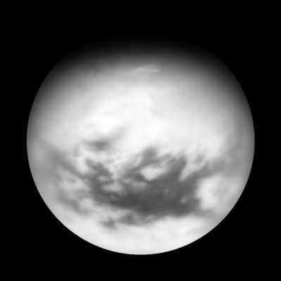 An "Orthographic View" of Titan
Caption NASA:"Cassini acquired this view of Titan on April 13, 2007, following a flyby of the Mercury-sized moon. Titan's equatorial Dark Regions are visible in this view, along with faint, dark lineaments (linear features) in the otherwise bland-looking terrain of the North. Near the Terminator are the dark, lake-like features identified in Cassini flybys early in 2007. 
To the east of the lake-like features is a bright patch of clouds that likely consist of a mixture of Methane and Ethane. 
This view of Titan is an orthographic reprojection centered on 27,4° North Latitude. An orthographic view is most like the view seen by a distant observer looking through a telescope.

The view was obtained using a filter sensitive to near-infrared light centered at 939 nanometers, allowing for observations of Titan's Surface and Lower Atmosphere, added together. An image taken using a filter sensitive to visible light centered at 619 nanometers was then subtracted from the product, effectively removing the lower atmosphere contribution to the brightness values in the image, increasing image contrast and improving the visibility of surface features. 

The Cassini spacecraft acquired this view with its narrow-angle camera at a distance of approx. 1,2 MKM (about 800.000 miles) from Titan. Image scale is roughly 7 Km (such as about 5 miles) per pixel". 


Parole chiave: Saturn's Moons - Titan