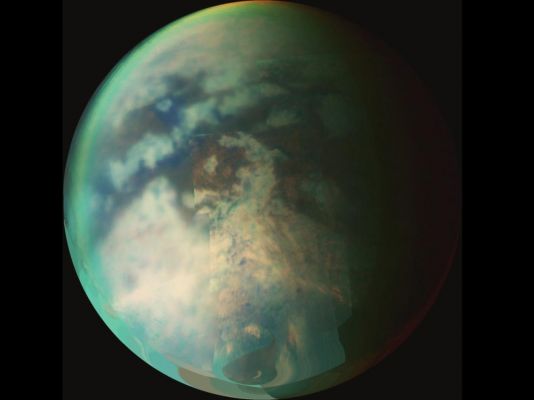 Cloudless Titan...
Caption NASA originale:"This image is a composite of several images taken during two separate Titan flybys on Oct. 9 (T19) and Oct. 25 (T20), 2006. 
The large circular feature near the center of Titan's disk may be the remnant of a very old impact basin. The mountain ranges to the South-East of the circular feature and the long dark, linear feature to the North-West of the old impact scar may have resulted from tectonic activity on Titan caused by the energy released when the impact occurred. 

The Oct. 9 images form the background globe for context and the most recent images from the Oct. 25 flyby are overlaid. The Oct. 9 images were taken at an average distance of about 30,000 Km (approx. 18.000 miles). The Oct. 25 images were taken at a distance of 12.000 Km (about 7.200 miles). The images were taken at wavelengths of 1,3 microns shown in blue, 2 microns shown in green and 5 microns shown in red".
Parole chiave: Saturn's Moons - Titan