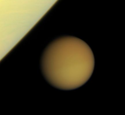 Titan approaches Saturn (natural colors; credits: NASA)
Caption NASA:"Swathed in its thick blanket of atmosphere, frigid Titan approaches the brilliant limb of Saturn. This view was obtained just minutes after the wide-angle view, "Father and Son". 

Images taken using red, green and blue spectral filters were combined to create this natural color view. The images were acquired with the Cassini spacecraft narrow-angle camera on Jan. 29, 2008 at a distance of approx. 2,3 MKM (such as about 1,4 MMs) from Titan. 
Image scale is roughly 14 Km (about 8 miles) per pixel".
Parole chiave: Saturn and Titan
