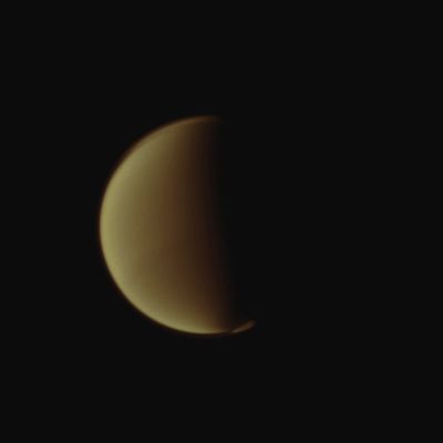 At Titan's Poles (Absolute Natural Colors; credits for the additional process. and color.: Dr Paolo C. Fienga - Lunar Explorer Italia/Italian Planetary Foundation) 
Titan's South Polar Vortex seems to "float" above the moon's South Pole in this NASA - Cassini Spacecraft view. The Vortex, which is a mass of gases swirling around the South Pole, high in the moon's Atmosphere, can be easily seen in the lower right of this view. On the other hand, Titan's Northern "Hood" is also well visible, since it covers almost all the Northern Regions of this always mysterious and fascinating Saturnian moon. This view looks toward the Leading Hemisphere of Titan (which is approx. 3200 miles, or about 5150 kilometers across). North on Titan is up and rotated 25° to the left. 
The image was taken with the NASA - Cassini Spacecraft Narrow-Angle Camera on July 6, 2012, using a Spectral Filter sensitive to wavelengths of Near-InfraRed light, centered at 889 nanometers. The view was acquired at a distance of approximately 1,7 Million Miles (such as about 2,8 Million Kilometers) from Titan and at a Sun-Titan-Spacecraft, or Phase, Angle of 86°. Scale in the original image was about 11 miles (such as approx. 17 Km) per pixel. Afterwards, the image has been contrast enhanced and magnified, so to improve the visibility of the most interesting Features existing in the Titanian Atmosphere.
This picture (which is an Original NASA - Cassini Spacecraft frame published on the NASA - Planetary Photojournal with the ID n. PIA 14626) has been additionally processed and then colorized, according to an informed speculation carried out by Dr Paolo C. Fienga (LXTT-IPF), in Absolute Natural Colors (such as the colors that a human eye would actually perceive if someone were onboard the NASA - Cassini Spacecraft and then looked outside, towards the Saturnian moon Titan), by using an original technique created - and, in time, dramatically improved - by the Lunar Explorer Italia Team. Different colors, as well as different shades of the same color, mean, among others, the existence of different Elements present in the Atmosphere of Titan, each having a different Albedo (---> Reflectivity) and Chemical Composition.
Parole chiave: Titan