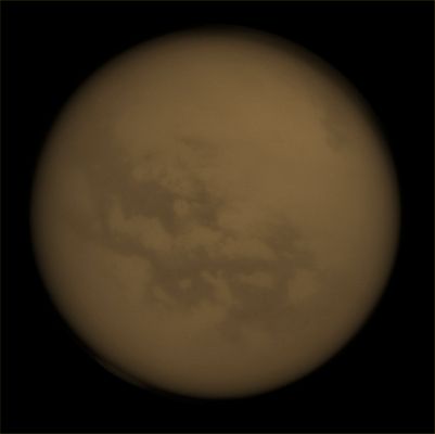 Fensal, Aztlan and Kraken Mare (Absolute Natural Colors; credits for the additional process. and color.: Dr Paolo C. Fienga/Lunar Explorer Italia/Italian Planetary Foundation)
Although it is almost completely hidden from human eyes, the NASA - Cassini Spacecraft can still spot a few dark Features on the Surface of Titan thanks to its special Near-InfraRed Filters. The Surface Features visible here, near the Equatorial Belt, have been dubbed "Fensal" and "Aztlan" by Planetary Scientists and they are believed to be vast (---> large and very long) Dunes made of Particles of Dust (mixed-up with, most likely, other Elements) that precipitated out of the Atmosphere of Titan (but some other possibilities about their origin and composition can also be well considered); on the other hand, near the North Pole of Titan, it is also well visible the largest body of liquids existing on this fascinating Saturnian moon, such as the Kraken Mare. 
Furthermore, just barely visible right on top of the South Pole, the huge Vortex that was spotted quite some time ago and that keeps Planetary Scientists busy trying to understand the actual reasons that caused its sudden formation, as well as and the amount of time during which it will still remain active (obviously assuming that such a Vortex is just a seasonal and not a - now - permanent phenomenon).

This view looks toward the Saturn-facing Hemisphere of Titan; North is up and rotated 32° to the right (Dx) and the image was taken with the NASA - Cassini Spacecraft Narrow-Angle Camera on April 13, 2013 using a Spectral Filter sensitive to Wavelengths of Near-InfraRed Light centered at 938 nanometers. The view was acquired at a distance of approximately 1,2 Million Miles (such as about 1,93 Million KiloMeters) from Titan and at a Sun-Titan-Cassini Spacecraft, or Phase, Angle of 4°. The image scale is roughly 7 miles (such as about 11,26 Km) per pixel.

This picture (which is an Original NASA - Cassini Spacecraft b/w frame published on the NASA - Planetary Photojournal and identified by the n. PIA 14663) has been additionally processed, magnified and then colorized, according to an educated guess carried out by Dr Paolo C. Fienga (LXTT-IPF), in Absolute Natural Colors (such as the colors that a human eye would actually perceive if someone were onboard the NASA - Cassini Spacecraft and then looked outside, towards the Saturnian moon Titan), by using an original technique created - and, in time, dramatically improved - by the Lunar Explorer Italia Team. Different colors, as well as different shades of the same color, mean, among others, the existence of different Elements present in the Atmosphere of Titan, each having a different Albedo (---> Reflectivity) and Chemical Composition. 

Note: it is possible (but we, as IPF, have no way to be one-hundred-percent sure of such a circumstance), that the actual luminosity of the Clouds and Hazes (as well as the luminosity of Titan itself) seen in this frame would appear, to an average human eye, way lower than it has been shown (or, better yet: interpreted) here.
Parole chiave: Titan