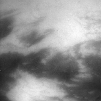 Adiri Region
Caption NASA:"Peering through Titan's thick haze, the Cassini spacecraft glimpses boundaries between bright and dark terrain on the moon's Trailing Hemisphere. 
The bright terrain at bottom is in North-Western Adiri. 
North on Titan is up and rotated about 15 degrees to the right. 
This view was created by combining multiple images taken using a combination of spectral filters sensitive to wavelengths of infrared light centered at 938 and 619 nanometers. Some processing artifacts remain in the finished image, including the two small, dark circles below and right of center. 
The images were taken with the Cassini spacecraft narrow-angle camera on May 13, 2007 at a distance of approx. 237.000 Km (about 147.000 miles) from Titan. Image scale is roughly 3 Km per pixel. Due to scattering of light by Titan's hazy atmosphere, the sizes of surface features that can be resolved are a few times larger than the actual pixel scale".
Parole chiave: Saturn's Moons - Titan