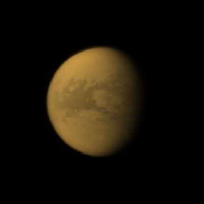 Belet Region on Titan (Natural Colors; credits: Dr Paolo C. Fienga - Lunexit Team)
Caption NASA:"The Cassini Spacecraft looks toward the dark Region of Belet, on Saturn's largest moon, Titan.
This large Region on the moon has a low albedo, meaning it diffusely reflects little light. This view looks toward the area between the Trailing Hemisphere and the Anti-Saturn Side of Titan. North on Titan is up and rotated 8° to the left.

The image was taken with the Cassini Spacecraft wide-angle camera on Dec. 28, 2009 using a spectral filter sensitive to wavelengths of Near-InfraRed Light centered at 939 nanometers. The view was obtained at a distance of approx. 282.000 Km (such as about 175.000 miles) from Titan and at a Sun-Titan-Spacecraft, or Phase, Angle of 45°. 
Image scale is roughly 17 Km (about 10 miles) per pixel".
Parole chiave: Titan