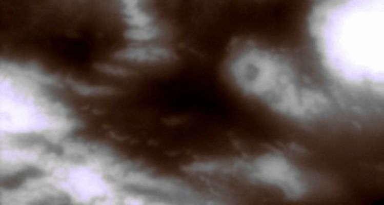 Shangri-la and other Equatorial Regions of Titan
Caption NASA:"This view of Titan's surface highlights NorthWestern Shangri-la - a large, Equatorial Dark Region revealed by radar observations to be covered in longitudinal dune fields. The bright, circular feature right of center is a potential impact crater - few of which have been spotted on Titan thus far. 
North on Titan is up and rotated about 15° to the right. This view was created by combining multiple images taken using a combination of spectral filters sensitive to wavelengths of infrared light centered at 938 and 619 nanometers. 

The images were taken with the Cassini spacecraft narrow-angle camera on May 13, 2007 at a distance of approx. 125.000 Km (about 77.000 miles) from Titan. Image scale is roughly 1 Km (0,6 miles) per pixel. Due to scattering of light by Titan's hazy atmosphere, the sizes of surface features that can be resolved are a few times larger than the actual pixel scale".
Parole chiave: Saturn's Moons - Titan