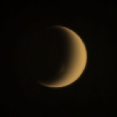 Double Crescent (Absolute Natural Colors; credits for the additional process. and color.: Dr Paolo C. Fienga/Lunar Explorer Italia/IPF)
Titan's South Polar Vortex mimics the moon itself, creating - as you can (barely) see in this frame, taken by the NASA - Cassini Spacecraft on December, 1, 2013 - a somehow elegant "crescent within a crescent". In fact, situated above the (surrounding) South Polar Atmosphere, the raised Walls of the Vortex, which stand along its Sunward Side, can just catch the grazing Sunlight, thus creating a "crescent" of its own. Titan (that, as you should know by now, is approx. 3200 miles - such as about 5149,88 Km - across) is Saturn's largest moon and possesses an extremely dense and ultra-dynamic Atmosphere, whose true characteristics are still a mistery. 

Speaking of unanswered questions as well as problems which are still unsolved, we have to say - as IPF - that the true nature (---> meaning Seasonal or Permanent) of the South Polar Vortex keeps being, up to now, an highly controversial subject in the Planetary Scientists' Community. However, a definitive answer about the aforementioned question - and we like to say "obviously" -, will come, in a way or another, in time. For now, the only - truly - wise thing to do, is to keep looking... 

This view looks toward the Trailing Hemisphere of Titan and North is up. The image was taken with the NASA - Cassini Spacecraft Wide-Angle Camera - as we wrote herebefore - on December, 1, 2013, by using a Spectral Filter which preferentially admits Wavelengths of Near-InfraRed Light centered at 939 nanometers. This frame was obtained at a distance of approximately 108.000 miles (such as about 173.808,72 Km) from Titan and the scale is roughly 6 miles (such as approx. 9,65 Km ) per pixel.

This frame (which is an Original NASA - CASSINI Spacecraft's b/w and NON Map-Projected image published on the NASA - Planetary Photojournal with the ID n. PIA 17163) has been additionally processed, contrast enhanced, magnified to aid the visibility of the details, Gamma corrected and then colorized - according to an educated guess (or, if you wish, an informed speculation) carried out by Dr Paolo C. Fienga - in Absolute Natural Colors (such as the colors that a human eye would actually perceive if someone were onboard the NASA - Cassini Spacecraft and then looked outside, towards the Saturnian moon "Titan"), by using an original technique created - and, in time, dramatically improved - by the Lunar Explorer Italia Team. Different colors, as well as different shades of the same color, mean, among other things, the existence of different Elements (Gases) present in the Atmosphere of Titan, each having a different Albedo (---> Reflectivity) and Chemical Composition.

Note: it is possible (but we, as IPF, have no way to be one-hundred-percent sure of such a circumstance), that the actual luminosity of Titan - as it is in this frame - would appear, to an average human eye, a little bit lower than it has been shown (or, better yet: interpreted) here.
Parole chiave: Titan