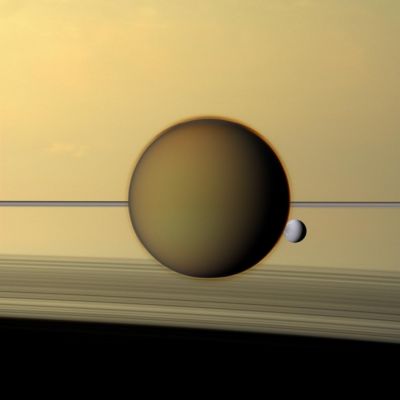 Titan and Dione (Natural Colors; credits: NASA/JPL-Caltech/Space Science Institute)
Caption NASA:"Saturn's third-largest moon, Dione, can be seen through the Haze of the Ringed-Planet's largest moon, Titan, in this Cassini Spacecraft's view of the two, just posing before Saturn and its Rings. The North Polar "Hood" of Titan can be seen appearing as a detached layer at its top

This view looks toward the sides of Titan and Dione that are facing away from Saturn. North is up on both moons. This view looks toward the Northern, sunlit side of the Rings from just above the Ring-Plane.

Images taken using red, green and blue spectral filters were combined to create this Natural Color view. The images were obtained with the Cassini Spacecraft narrow-angle camera on May 21, 2011, at a distance of approx. 1,4 MMs (such as about 2,3 MKM) from Titan and approx. 2 MMs (such as about 3,2 MKM) from Dione. Image scale is roughly 9 miles (about 14 Km) per pixel on Titan and roughly 12 miles (approx. 19 Km) on Dione".
Parole chiave: Saturnian Moons - Dione and Titan