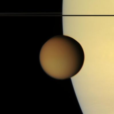 In-Transit...
The murky orange disk of Saturn's moon Titan glides past -- a silent, floating sphere transiting Saturn. 
Titan's photochemical smog completely obscures the surface in such natural color views. Its high-altitude hazes are visible against the disk of Saturn as they attenuate the light reflected by the Planet. 
This view was acquired from less than 1° above Saturn's Ring-Plane. 

Images taken using red, green and blue spectral filters were combined to create this natural color view. The images were obtained with the Cassini spacecraft narrow-angle camera on Aug. 1, 2007, at a distance of approx. 2,4 MKM (such as about 1,5 MMs) from Titan. Image scale is roughly 15 Km (about 9 miles) per pixel.
Parole chiave: Saturn and Titan