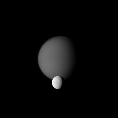 Brothers in the Night
Caption NASA:"The Cassini Spacecraft watches a pair of Saturn's moons, showing the hazy orb of giant Titan beyond smaller Tethys.
In the foreground of the image, Ithaca Chasma can be seen running roughly North-South for more than 1000 Km (about 620 miles) on Tethys. Titan's detached, high-altitude Haze Layer and North Polar "Hood" are also visible here.
This view looks toward the Saturn-facing sides of Titan and Tethys.

The image was taken in Visible Green Light with the Cassini Spacecraft narrow-angle camera on Oct. 18, 2010. The view was obtained at a distance of approx. 2,5 MKM (such as about 1,6 MMs) from Titan and at a Sun-Titan-Spacecraft, or Phase, Angle of 55°. The view was obtained at a distance of approx. 1,5 MKM(such as about 930.000 miles) from Tethys and at a Sun-Tethys-Spacecraft, or Phase, Angle of 55°".
Parole chiave: Saturnian Moons - Titan and Tethys