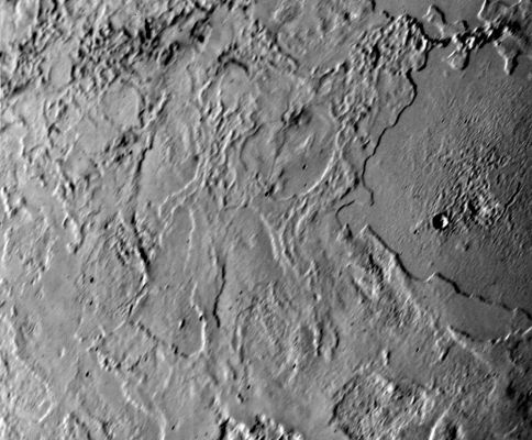 Northern Latitudes on Triton
Voyager 2 took this picture of Neptune's largest satellite, Triton, from less than 80.000 Km (about 50.000 miles). The image shows an area in Triton's Northern Hemisphere. 
The Sun is just above the horizon, so features cast shadows that accentuate height differences. The large, smooth area in the right-hand side of the image shows a single, fresh, impact crater. Otherwise there is no evidence of impacts such as those that have pocked the faces of most of the satellites Voyager 2 has visited. 
Many low cliffs in the area, bright where they face the Sun, and when they face away from it, suggest and intricate history for Triton. The cliffs might be due either to melting of surface materials or, possibly, caused by unusual fluid materials that flowed sometime in Triton's past.
Parole chiave: Neptune's Moon - Triton