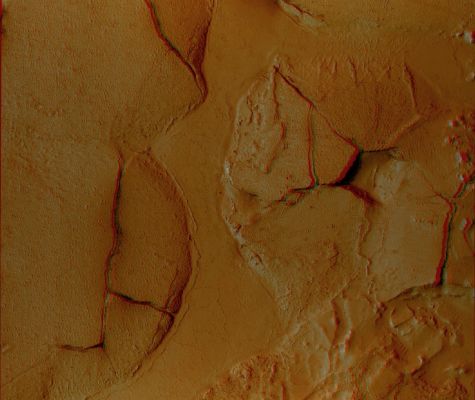 Fractured Mounds in Elysium Planitia (3D and Enhanced Natural Colors; credits: NASA and Lunar Explorer Italia)
This stereo view shows fractured mounds on the southern edge of Elysium Planitia on Mars. It combines two images taken by the High Resolution Imaging Science Experiment (HiRISE) camera on NASA's Mars Reconnaissance Orbiter. When seen through red-green (or blue) glasses, the view appears three dimensional. 
This is one example of 362 stereo views posted by the HiRISE team on Dec. 8, 2008, at http://hirise.lpl.arizona.edu/anaglyphs. This view spans an area about 6 Km (3,7 miles) wide. 

The mounds on the southern edge of Elysium Planitia are typically a few kilometers or miles in diameter and about 60 meters (200 feet) tall. Fractures that crisscross their surfaces are dilational (extensional) in nature, suggesting that the mounds formed by localized uplift (meaning that they were pushed up from below). 
The 3D perspective shows that the uplift is not uniform along a fracture and can favor one side. 
The mounds are probably composed of solidified lava. They are contiguous with, and texturally similar to, flood lavas that blanket much of Elysium Planitia. Where dilation cracks provide cross-sectional exposure, the uplifted material is rocky. 

Patches of mechanically weak and disrupted material overlie the rocky mound material. This is particularly conspicuous in the northeast corner of the image. These patches may be remnants of a layer that was once more continuous but has been extensively eroded. Smooth lava plains fill the low-lying areas between the mounds. They are riddled with sinuous pressure ridges. The entire area is covered by a relatively thin layer of dust and sand. 

One of the HiRISE images used in this stereo view is catalogued as PSP_003597_1765, taken May 3, 2007, and as PSP_002542_1765, taken Feb. 10, 2007. The location is about 3° South Lat. and 168° East Long. .
Parole chiave: Mars from orbit - Elysium Planitia (3D)