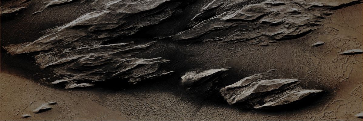 Streamlined Rocky Outcrops near Olympus Mons (Enhanced Absolute Natural Colors; credits for the additional process. and color.: Dr Paolo C. Fienga - Lunar Explorer Italia)  
Caption NASA originale:"This MGS-MOC image shows wind-eroded "Streamlined" Rocky Outcrops overlying Lava Flow Surfaces located to the West of Olympus Mons. Outcrops with this appearance are also called Yardangs. Yardangs typically form in Sedimentary Rock or Volcanic Ash that contains some amount of Sand. The weathering of the Rock due to the Aeolian action cause the release of sand-sized particles from the Outcrops and, in time, such a form of erosion slowly shape the rock into the classic, inverted boat hull-like shapes of Yardangs". 

Location near: 13,2° North Lat. and 160,1° West Long.
Image width: ~3 Km (~1,9 mi) 
Illumination from: lower left 
Season: Northern Spring
Parole chiave: Mars from orbit - Volcanic Features - Rocky Outcrops