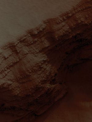 Layers in the lower West Flank of Arsia Mons (Absolute Natural Colors; credits for the additional process. and color.: Dr Paolo C. Fienga - Lunexit Team)
Caption NASA:"This image - dated July, 18th, 2007) covers a Pit in the lower West Flank of Arsia Mons, one of the four Giant Volcanoes of the Tharsis Volcanic District.
Many Layers are exposed in the Pit, probably marking individual Lava Flows, and they can provide useful information about the nature of some of the many Martian Volcanic Eruptions. 

This image was acquired in the middle of a large Regional Dust Storm, but the Atmosphere over this image is only moderately dusty because the altitude is 6,5 Km higher than the Planetary Mean, so the air is quite thin and cannot hold as much Dust. Although the Atmosphere was not too dusty, the Surface is buried by a Dust Layer which is probably several meters thick. 
These high-altitude locations on Mars have thick Dust Deposits because the thin air cannot blow away the Dust, or at least not as fast as it accumulates. On Earth the oceans serve as "Dust Traps", but on Mars, it is a job for the highest Volcanoes".
Parole chiave: Mars from orbit - Volcanoes - Arsia Mons