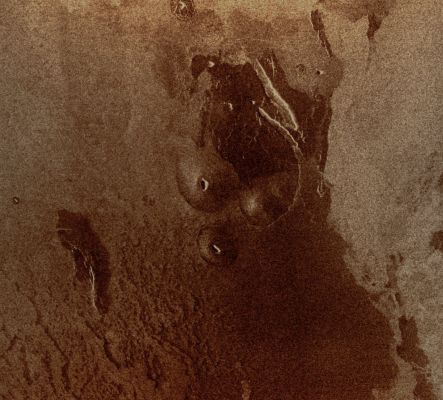 Volcanic Domes on the Flank of Maat Mons - East Ovda Region (possible Natural Colors; credits: Dr Paolo C. Fienga - Lunexit Team)
This Magellan image is centered at about 3,2° North Latitude and 194,9° East Longitude, in the Eastern Ovda Region of Venus. 
The image, which is approx. 90 Km (about 56 miles) in width and approx. 80 Km (such as about 50 miles) in length, shows some small Volcanic Domes on the Flank of the volcano Maat Mons. The bright flows to the East are most likely rough Lava Flows while the darker flows to the West are probably smoother flows. The dark flows do show some roughness, however, as can be seen by the structure in the flows to the South/West. 
These dark flows also have some debris that has been deposited on top of them. The debris may be fine material from the surrounding Plains on top of the flow by wind or it may be ash from the volcano. 
Small Volcanic Domes are very common features on the Surface of Venus, indicating that there has been (and maybe there still is) much volcanic activity going on almost everywhere. 
Assuming that the central Volcanic Cone is symmetrical in shape and knowing the length of the cone's side and the incidence angle, radar foreshortening yields a height and slope of 688 meters and 8,2°, respectively, for the Cone. 
These values are similar to heights and slopes of some Volcanic Cones on the Earth. 
Parole chiave: Venus from orbit - Volcanic Features - Domes