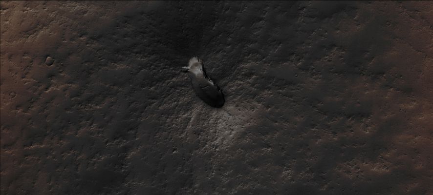 The "Footprint" Volcano (Absolute Natural Colors; credits for the additional process. and color.: Drr Don P. Mitchell and Paolo C. Fienga - Lunexit Team)
This NASA - Mars Global Surveyor (MGS) - Mars Orbiter Camera (MOC) High Resolution image, acquired on the date of July, 13, 2003, shows a small, Dust-covered and so far - officially - Unnamed Volcano (note: the nickname "Footprint" has been given to this Surface Feature by the Researchers of the Italian Planetary Foundation) that is located on the Volcanic Plains to the East of the Giant Martian Volcano, Pavonis Mons. 
It is interesting to notice that the Floor of the Caldera - such as the elliptical depression visible at the Summit of the Volcano - has a few windblown Ripples on it. The Ripples and the extremely thick Dust Mantle, together with a number of small Impact Craters located on its Surface, are signs which indicate that the "Footprint" Volcano erupted a VERY long time ago, and that there has been no more activity in (geologically speaking) recent times. In addition to the above, we also wish to underline that, while the Surface surrounding the Footprint Volcano has kept, despite the eons of volcanic idleness, a dark gray color (such as the typical colors of Lava, once is cooled off, and Volcanic Ashes), the Land that is farther away from the Volcano has maintained (or maybe re-gained?) the typical brown-orange color which characterizes most of the Equatorial and Peri-Equatorial Surface of Mars. This image covers an area approx. 3 by 6,8 Km wide (such as approx. 1,9 by 4,2 miles). The Footprint Volcano is located near 1,6° South Lat. and 105,7° West Long.; the Sunlight illuminates the scene from the South.
The frame has been colorized in Absolute Natural Colors (such as the colors that a human eye would actually perceive if someone were onboard the NASA - Mars Global Surveyor Orbiter and then looked down, towards the Surface of Mars), by using an original technique created - and, in time, dramatically improved - by the Lunar Explorer Italia Team.
Parole chiave: Mars from orbit - Volcanoes - Footprint