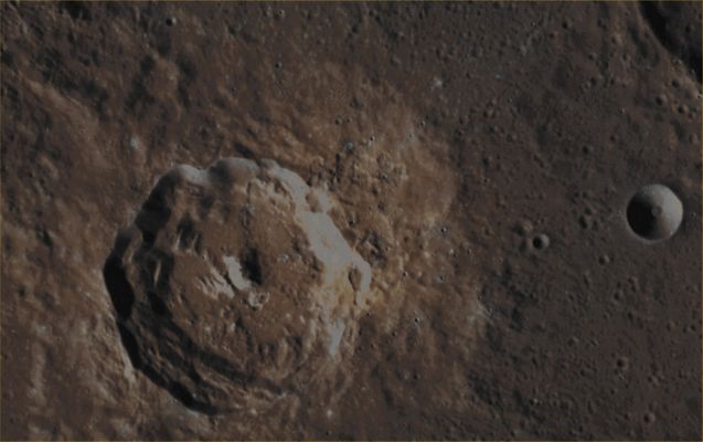 Unnamed and (relatively) Fresh Impact Crater (EDM - Absolute Natural Colors; credits for the additional process. and color.: Dr Paolo C. Fienga/Lunar Explorer Italia/Italian Planetary Foundation)
This Absolute Natural Color Image-Mosaic shows us a bright (and, of course, relatively speaking, "fresh") Complex Mercurian Impact Crater - approx. 33 Km (such as about 20,49 miles) in diameter -  that exhibits Terraced and Multi-Layered Inner Walls and Slopes - with some Collapse Feature (Mass-Wasting?) here and there -, an also quite Complex Central Peaks' System and, last but not least, the (more than just) possible evidence of a large Pyroclastic Deposit located on it's Eastern Side (---> Dx of the Crater for the Observer), and mostly concentrated in the Region going from about 1 to 4 o'clock of its Outer Surroundings.

Date acquired: November, 6th, 2011
Images Mission Elapsed Time (MET): 229105596, 229105592, 229105588
Images ID: 980566, 980565, 980564
Instrument: Wide Angle Camera (WAC) of the Mercury Dual Imaging System (MDIS)
Center Latitude: 25,42° North
Center Longitude: 266,80° East
Solar Incidence Angle: 52,3° (meaning that the Sun, at the time that the picture was taken, was about 37,7° above the imaged Local Mercurian Horizon)
Emission Angle: 16,8°
Sun-Mercury-Messenger (or "Phase") Angle: 69,1°

This picture (which is a crop from an Original NASA - MESSENGER Spacecraft's false colors Map-Projected image-mosaic published on the NASA - Planetary Photojournal with the ID n. PIA 17290) has been additionally processed, contrast enhanced, magnified and then re-colorized in Absolute Natural Colors (such as the colors that a human eye would actually perceive if someone were onboard the NASA - MESSENGER Spacecraft and then looked down, towards the Surface of Mercury), by using an original technique created - and, in time, dramatically improved - by the Lunar Explorer Italia Team. Different colors, as well as different shades of the same color, mean, among other things, the existence of different Elements (Minerals) present on the Surface of Mercury, each having a different Albedo (---> Reflectivity) and Chemical Composition.
Parole chiave: Mercury from orbit - Craters - Unnamed Crater with Central Peak and Terraces