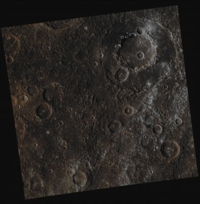 Wang Meng Crater, in context (Possible Absolute Natural Colors; credits for the additional process. and color.: Dr Paolo C. Fienga/Lunar Explorer Italia/Italian Planetary Foundation)
The large Wang Meng Impact Basin (whose diameter is approx. 165 Km - such as about 102,465 miles) can clearly be see in the top right of this image, which is a mosaic made out of three frames taken by the NASA - MESSENGER Spacecraft on April, 20, 2013. This Absolute Natural Color view of the Impact Basin shows us, among many other extremely interesting things, the strong contrast between the dark Low Reflectance Material (or "LRM", for short) which is located on the Eastern Portion of Wang Meng's Peak Ring and the brighter Western Portion of the Peak Ring itself, as well as the bright white Rays that spread across the right side (---> West) of the picture. 
While some of the Hollows existing on and near the Crater's Peak Ring and Outer Rim are, somehow, "associated" (here and there, and always unevenly) with Low Reflectance Material, as evidenced by their bright white halos, the Rays that are visible here (---> such as towards the Western and South/Western sides of the frame) are, in fact, coming from other Impact Craters located in Wang Meng's proximities - including the small, fresh Impact Crater visible towards the right corner of the picture, just in betwenn the Peak Ring and the Outer Rim of Wang Meng. 

Date acquired: April, 20th, 2013
Images Mission Elapsed Time (MET): 8743264, 8743256, 8743260
Images ID: 3915336, 3915334, 3915335
Instrument: Wide Angle Camera (WAC) of the Mercury Dual Imaging System (MDIS)
Center Latitude: 6,33° North
Center Longitude: 254,10° East
Solar Incidence Angle: 41,6° (meaning that the Sun, at the time that the pictures were taken, was about 48,4° above the imaged Local Mercurian Horizon)
Emission Angle: 0,2°
Sun-Mercury-Messenger (or "Phase") Angle: 41,7°

This frame (which is an Original NASA - MESSENGER Spacecraft's false colors and Map-Projected image-mosaic published on the NASA - Planetary Photojournal with the ID n. PIA 17239) has been additionally processed, contrast enhanced, magnified to aid the visibility of the details, Gamma corrected and then re-colorized in Absolute Natural Colors (such as the colors that a human eye would actually perceive if someone were onboard the NASA - MESSENGER Spacecraft and then looked down, towards the Mercurian Impact Crater "Wang Meng"), by using an original technique created - and, in time, dramatically improved - by the Lunar Explorer Italia Team. Different colors, as well as different shades of the same color, mean, among other things, the existence of different Elements (Minerals) present on the Surface of Mercury, each having a different Albedo (---> Reflectivity) and Chemical Composition.
Parole chiave: Mercury from orbit - Craters - Wang Meng Crater