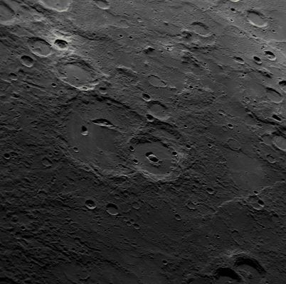 Evidence of Volcanism on Mercury
Some impact craters on Mercury have non-circular, irregularly shaped depressions or pits on their floors. Such craters have been termed "Pit-Floor Craters", and MESSENGER team members have suggested that such Pits formed by the collapse of subsurface magma chambers. If this suggestion is correct, the pits are evidence of volcanic processes at work on the Solar System's innermost Planet. With high-resolution images from MESSENGER's 3rd Mercury flyby, more pit-floor craters are being identified on Mercury's Surface. 
This NAC image shows a good view of a Pit-Floor Crater imaged last week prior to closest approach. The large crater near the center of the image contains an elongated bean-shaped depression on its floor and is a Pit-Floor Crater. The slightly smaller crater to the South also contains a pair of depressions on its floor, though from this image alone it cannot be determined if the depressions are pits or overlapping impact craters. Other examples of pit-floor craters discovered in MESSENGER images include Beckett, Gibran, and another newly imaged crater from Mercury flyby 3. 

Date Acquired: September 29, 2009
Image Mission Elapsed Time (MET): 162744290
Instrument: Narrow Angle Camera (NAC) of the Mercury Dual Imaging System (MDIS)
Resolution: 390 meters/pixel (0.24 miles/pixel)
Scale: this image is about 400 Km (approx. 250 miles) from top to bottom
Spacecraft Altitude: about 15.200 Km (approx. 9400 miles)
Parole chiave: Mercury's Fly-By
