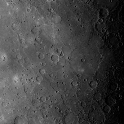 Smooth Plains and Impact Craters
This scene, a mosaic of images acquired as MESSENGER approached Mercury for its third fly-by of the Planet, shows a large expanse of Smooth Volcanic Plains near the center of the image. 
Most Smooth Plains are believed to have formed by Lavas that flooded Mercury's Surface. In this view, Craters are visible that have been nearly filled with Lava, leaving only traces of their Circular Rims. 
Curving Scarps (or "Cliffs") and "Wrinkle Ridges" can also be seen running mostly from top to bottom of the frame. The density of Impact Craters on the Smooth Plains is less than on the heavily Cratered Terrain visible in the upper right and lower right corners of this image. 
The presence of fewer Impact Craters per unit area means that the Volcanic Smooth Plains are younger than the Cratered Terrain. 
During orbital observations beginning in 2011, MESSENGER will gather high-resolution and color imaging data to map the global extent of Mercury's Volcanic Smooth Plains, gaining clues to the composition of the Plains and unraveling the History of Volcanism on the Solar System's Innermost Planet. The named craters Picasso, Firdousi and Steichen are visible in this scene.

Date Acquired: September, 29th, 2009
Instrument: Narrow Angle Camera (NAC) of the Mercury Dual Imaging System (MDIS)
Scale: The bottom edge of this image is approximately 1450 Km (900,45 miles) across
Parole chiave: Mercury's Fly-by