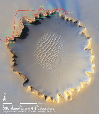 414 Soles around Victoria...
Caption NASA:"Victoria Crater, about 800 meters (one-half mile) in diameter, has been home ground for NASA's MER Opportunity for more than 14 of the Rover's first 46 months on Mars. This view shows the Rover's path overlaid on an image of the crater taken by the High Resolution Imaging Science Experiment on NASA's Mars Reconnaissance Orbiter. 

Opportunity first reached the crater's rim on Sept. 27, 2006, during the 951st Martian Day, or Sol, of the Rover's work in the Meridian Planum Region of Mars. 
The Rover then explored clockwise about 1/4th of the way around the rim before returning to a point close to its first overlook. 
On the mission's 1293rd Sol (Sept. 13, 2007), Opportunity began a sustained exploration of the interior of the Crater, entering at an alcove called "Duck Bay" on the Western Side of Victoria. 

This traverse map includes Opportunity's route through Sol 1365 (such as Nov. 26, 2007). The scale bar is 300 meters (984 feet) long.
Parole chiave: Maps