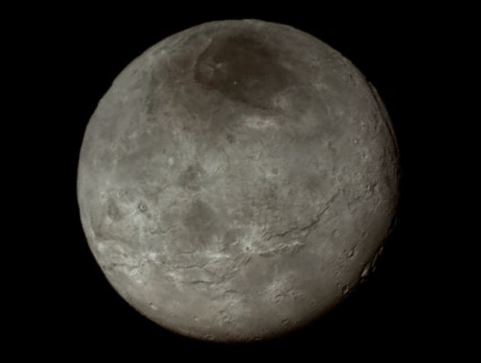 Charon (Absolute Natural Colors; credits for the additional process. and color.: Dr Paolo C. Fienga - Lunexit Team)
Remarkable new details of Pluto's largest moon Charon are revealed in this wonderful image from New Horizons' Long Range Reconnaissance Imager (or "LORRI", for short), that was taken late on July 13, 2015, from a distance of about 289.000 miles (such as approx. 465.099,26 Km). A swath of Cliffs and Troughs stretches about 600 miles (approx. 1609,34 Km) from left (Sx) to right (Dx), suggesting the occurrence, in a remote past, of a widespread fracturing of Charon's Crust (likely a result of internal processes). At the upper righ (Dx) of the framet, along the moon's curving edge, there is a Canyon that is estimated to be approx. 4 to 6 miles (such as about 6,437 to roughly 9,656 Km) deep.

The Mission Scientists are surprised by the apparent lack of Impact Craters on Charon. South of the moon's Equator, at the bottom of this image, Terrain is lit by the slanting Rays of the Sun, and thus creating shadows that make it easier to distinguish its real Topography. Even here, however, relatively few Impact Craters are visible, and this circumstance indicates a (relatively speaking) young Surface that, probably, has been often reshaped by Geologic Activites. 

In Charon's North Polar Regions, a dark marking - which was already prominent in the NASA - New Horizons Spacecraft' approach images - is now seen to have a diffuse (---> lighter in color) Boundary, suggesting that it could be a thin Deposit of Dark Material. Underlying, it is a distinct, sharply bounded, Angular Surface Feature; higher resolution images still to come are expected to shed more light on this truly enigmatic Region.

The image (which is an Original NASA - New Horizons Spacecraft's falsely colored and NON Map-Projected frame published on the NASA - Planetary Phojournal with the ID n. 19709) has been additionally processed, magnified to aid the visibility of the details, contrast enhanced and sharpened, Gamma corrected and then re-colorized (according to an educated guess carried out by Dr Paolo C. Fienga-LXTT-IPF) in Absolute Natural Colors (such as the colors that a normal human eye would actually perceive if someone were onboard the NASA - New Horizons Spacecraft and then looked ahead, towards the Plutonian moon Charon), by using an original technique created - and, in time, dramatically improved - by the Lunar Explorer Italia Team.
Parole chiave: Pluto's moons - Charon