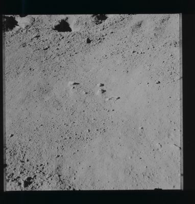 AS 15-86-11605 - The "Glass Sphere" and a "Pin-Pin"...
Caption NASA:"142:56:47 MT - At the start of EVA-2, Dave (Scott) took this cross-Sun from the north of the small Glass Sphere that he had noticed on the ground under the Rover stowage position prior to the first EVA at 108:30:36 MT. 
The piece of hardware on the ground is probably a so-called "pip-pin" that was pulled off the Rover during the deployment. The "aggie" is above the slightly-buried rock above and slightly to the right of the center of the picture".
Parole chiave: Lunar Surface - Glass Sphere and "Pin-Pin"