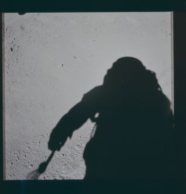 AS 15-86-11607 - My Shadow, the "Glass Sphere" and a "Pin-Pin"
Caption NASA:"142:56:47 MT - At the start of EVA-2, Dave (Scott) took 3 cross-Suns from the north of the small Glass Sphere that he had noticed on the ground under the Rover stowage position prior to the first EVA at 108:30:36 MT. 
This is the fourth of those pictures. 
The piece of hardware on the ground is probably a so-called "pip-pin" that was pulled off the Rover during the deployment. 
The "aggie" is just beyond the relatively large rock that is immediately above and to the left of the pip-pin".
Parole chiave: Lunar Surface - Glass Sphere and "Pin-Pin"